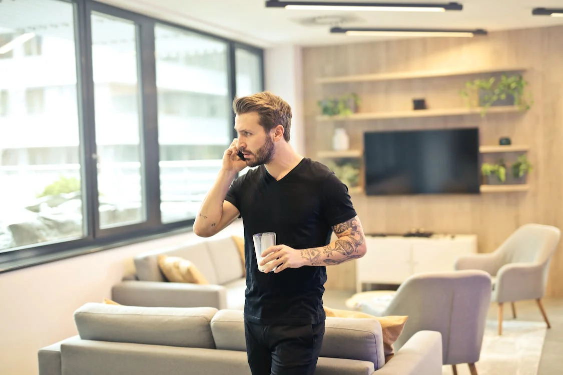man in apartment on phone call